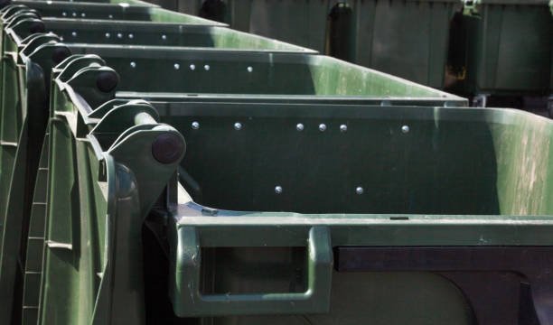 open empty green plastic waste containers (dustbins, garbage cans, trash cans).